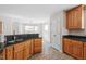 Traditional kitchen with wooden cabinets, dark countertops, and a breakfast nook with large windows at 2030 Lonesome Dove Dr, Franklinton, NC 27525