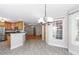 Eat-in kitchen with stainless steel appliances, wooden cabinets, and a decorative light fixture at 2030 Lonesome Dove Dr, Franklinton, NC 27525