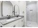 Bathroom featuring double sinks, granite countertops, and a tiled walk-in shower at 210 S General Lee Ave, Dunn, NC 28334