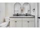 Bathroom featuring double sinks with granite counters and modern fixtures at 210 S General Lee Ave, Dunn, NC 28334