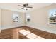Bright bedroom with wood floors and multiple windows offering lots of natural light at 210 S General Lee Ave, Dunn, NC 28334