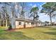 A cozy single-story home with stone accents, shutters, and a well-maintained lawn exudes warmth at 210 S General Lee Ave, Dunn, NC 28334