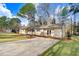 This inviting home has a long driveway and a beautiful lawn surrounded by large, mature trees at 210 S General Lee Ave, Dunn, NC 28334