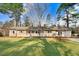 Charming single-story home with a well-manicured lawn and mature trees offering curb appeal at 210 S General Lee Ave, Dunn, NC 28334