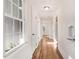 Bright hallway with hardwood floors, a window, and white trim and doors at 210 S General Lee Ave, Dunn, NC 28334