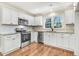 The spacious kitchen features stainless appliances, granite counters, and a tile backsplash at 210 S General Lee Ave, Dunn, NC 28334