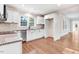 The kitchen boasts white cabinets, granite countertops, and stainless steel appliances at 210 S General Lee Ave, Dunn, NC 28334