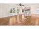 Spacious living room featuring gleaming hardwood floors, a stone fireplace, and abundant natural light at 210 S General Lee Ave, Dunn, NC 28334