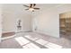 Main bedroom featuring a ceiling fan, a closet, and backyard access at 210 S General Lee Ave, Dunn, NC 28334