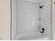 Stylish shower with white subway tile, black grout, and corner shelves at 210 S General Lee Ave, Dunn, NC 28334