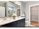 Bathroom featuring a double vanity, large mirror, and tiled walk-in shower at 2152 Pink Peony Cir # 155, Durham, NC 27703