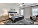 Cozy bedroom with stylish rug, ceiling fan, large bed, and soft lighting at 2152 Pink Peony Cir # 155, Durham, NC 27703