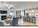 Open-concept living room with fireplace, adjacent dining area, and modern kitchen at 2152 Pink Peony Cir # 155, Durham, NC 27703