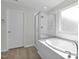 Bright bathroom featuring a glass shower with a tub and a view from the adjacent window at 2156 Pink Peony Cir # 157, Durham, NC 27703