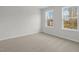Cozy bedroom featuring neutral carpet and large windows, creating a tranquil retreat at 2156 Pink Peony Cir # 157, Durham, NC 27703