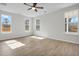 Bright bedroom featuring light walls, ceiling fan and multiple windows for ample natural light at 2156 Pink Peony Cir # 157, Durham, NC 27703