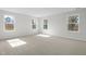 Spacious bedroom boasts multiple windows, plush carpet, and abundant natural light at 2156 Pink Peony Cir # 157, Durham, NC 27703