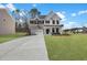Inviting home exterior with brick and white siding, highlighted by blue shutters and a lush green lawn at 2156 Pink Peony Cir # 157, Durham, NC 27703