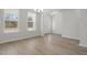 Bright foyer featuring hardwood floors, a modern chandelier, and a clear view of the home's entrance at 2156 Pink Peony Cir # 157, Durham, NC 27703