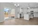 Bright kitchen features white cabinets, stainless steel appliances, and access to the patio at 2156 Pink Peony Cir # 157, Durham, NC 27703