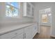 Well-organized pantry with white cabinetry, quartz countertops, and convenient access to the kitchen at 2156 Pink Peony Cir # 157, Durham, NC 27703