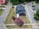An aerial view showcases the house's new roof, landscaping, and street view at 221 Charlotte Ave, Sanford, NC 27330