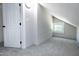 Finished attic space with bright white walls, carpet and a window providing natural light at 221 Charlotte Ave, Sanford, NC 27330