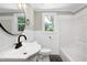 This traditional bathroom features a circular mirror and a white tiled shower at 221 Charlotte Ave, Sanford, NC 27330
