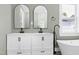 Bright bathroom featuring a stand alone tub, double vanity, and views to a closet and window at 221 Charlotte Ave, Sanford, NC 27330