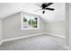 Empty bedroom with neutral paint, plush carpet and a large window, ready for personalization at 221 Charlotte Ave, Sanford, NC 27330