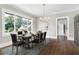 Formal dining room with modern chandelier and view from large window at 221 Charlotte Ave, Sanford, NC 27330