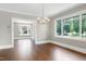 Light-filled dining room with hardwood floors and a modern chandelier at 221 Charlotte Ave, Sanford, NC 27330
