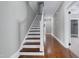 Inviting entryway showcasing hardwood floors, a staircase with white risers, and neutral paint at 221 Charlotte Ave, Sanford, NC 27330
