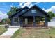 Charming two-story home with a covered front porch and a landscaped yard at 221 Charlotte Ave, Sanford, NC 27330