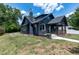 Charming exterior view of home with updated landscaping, walkway, and mature trees, with ample natural light at 221 Charlotte Ave, Sanford, NC 27330