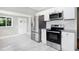 Kitchen with stainless steel appliances, white cabinets, granite countertops, and subway tile backsplash at 221 Charlotte Ave, Sanford, NC 27330