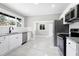 Bright kitchen featuring white cabinets, stainless steel appliances, and a view to the dining area at 221 Charlotte Ave, Sanford, NC 27330
