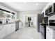 Bright kitchen featuring white cabinets, stainless steel appliances, and a view to the dining area at 221 Charlotte Ave, Sanford, NC 27330