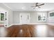 Inviting living room featuring a ceiling fan, hardwood floors, and many windows at 221 Charlotte Ave, Sanford, NC 27330
