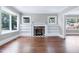 Bright living room featuring a fireplace with built-in bookshelves and large windows at 221 Charlotte Ave, Sanford, NC 27330