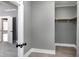 Large walk-in closet with gray paint, wood rod for storage and access to the main bedroom at 221 Charlotte Ave, Sanford, NC 27330