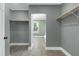 Spacious walk-in closet with modern gray paint and wood rods for storage at 221 Charlotte Ave, Sanford, NC 27330