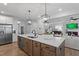 Bright and airy kitchen island with a stainless steel dishwasher in an open floorplan at 225 Savannah Moss Way # 120, Raleigh, NC 27603