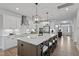 Bright, open kitchen with stainless steel appliances, quartz countertops, and a large center island with seating at 232 Augusta Pond Way # 124, Raleigh, NC 27603