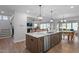 Open-concept kitchen featuring a large island, stainless steel appliances, and ample counter space at 232 Augusta Pond Way # 124, Raleigh, NC 27603