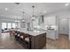 Spacious kitchen island with counter seating and modern pendant lighting at 232 Augusta Pond Way # 124, Raleigh, NC 27603