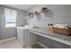 Functional laundry room with washer, dryer, counter space, and shelving for organized storage and convenience at 232 Augusta Pond Way # 124, Raleigh, NC 27603