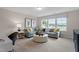 Cozy living room with plush seating, a large window with shades, and stylish decor for a comfortable space at 232 Augusta Pond Way # 124, Raleigh, NC 27603