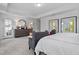 Bright primary bedroom with a cozy sitting area, modern decor, and ample natural light for a peaceful retreat at 232 Augusta Pond Way # 124, Raleigh, NC 27603