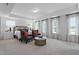 Spacious primary bedroom with large windows, cozy sitting area, and neutral tones for a relaxing retreat at 232 Augusta Pond Way # 124, Raleigh, NC 27603